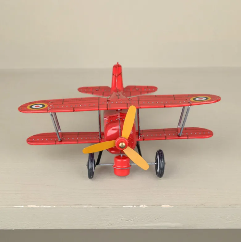 Avion biplan rouge mécanique
