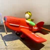 Tirelire le Petit Prince dans son avion